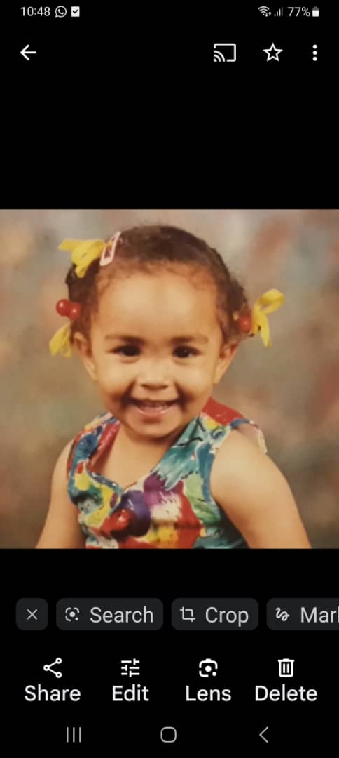 Famke as a child, smiling with ribbons in her hair